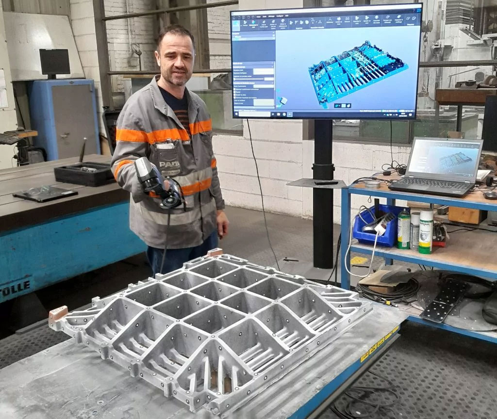 A worker using a HandySCAN BLACK to scan tooling