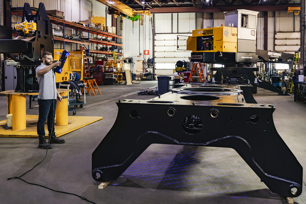 Engineer using the Creaform HandySCAN 3D|MAX Series to scan a massive and complex part with shiny surfaces in a production environment.