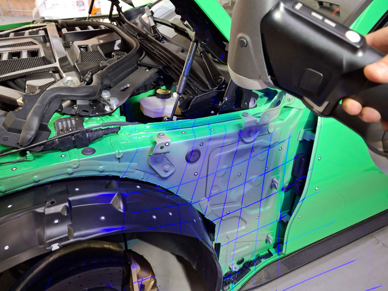 A team member at Karbonius Composites scans a sports vehicle using a HandySCAN 3D|BLACK Series 3D scanner.