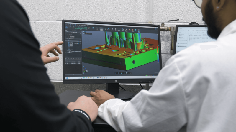 Quality control specialists looking at a colormap displayed with Creaform’s Inspection software on a computer screen