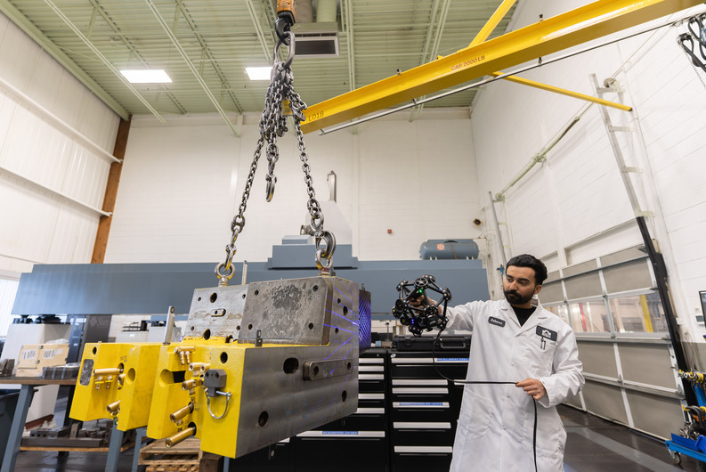 Engineer using the Creaform MetraSCAN BLACK+ to scan a car body with complex geometry and intricate areas