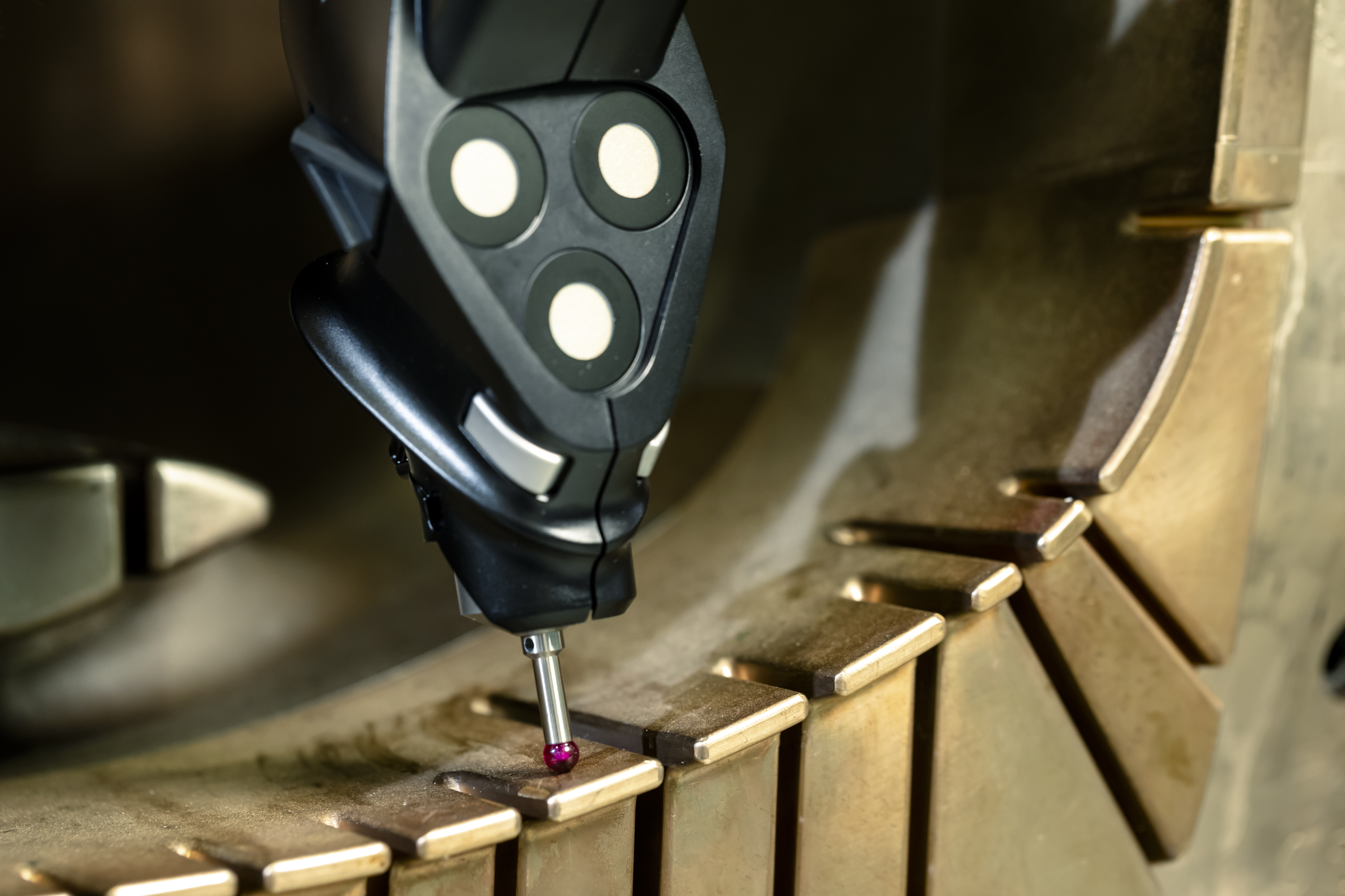 Metrologist using portable CMM to perform contact probing on an industrial mold for quality inspectio 