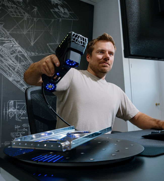 Expert 3D scanning a part with the EVO Series 3D scanner  in his office