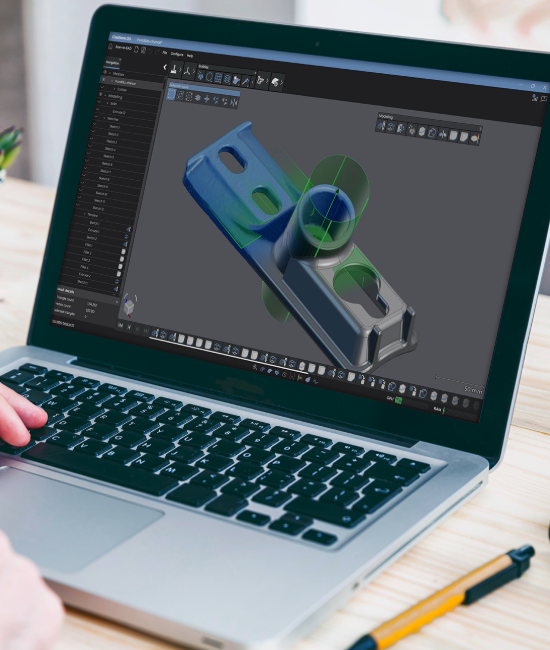Laptop screen displaying Scan-to-CAD Pro software with a detailed part sketching and modeling.