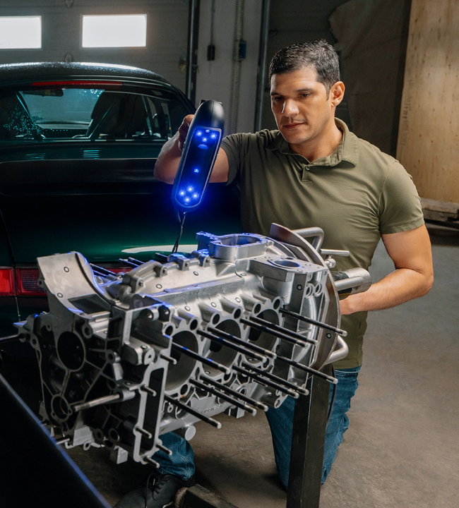 PRO Series 3D scanner inspecting a large engine block casting in an automotive workshop