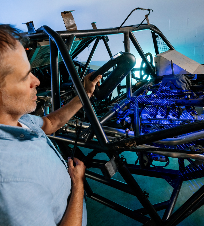 Expert scanning the frame and engine area of a vehicle with the PRO Series 3D scanner