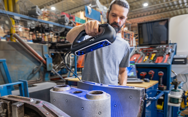 Person using a PRO Series 3D scanner to scan a mold in a factory setting