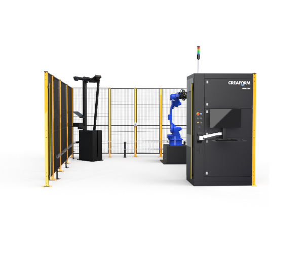 The M2 measuring cell with blue robot, table, calibration arm and Creaform control unit inside the safety enclosure